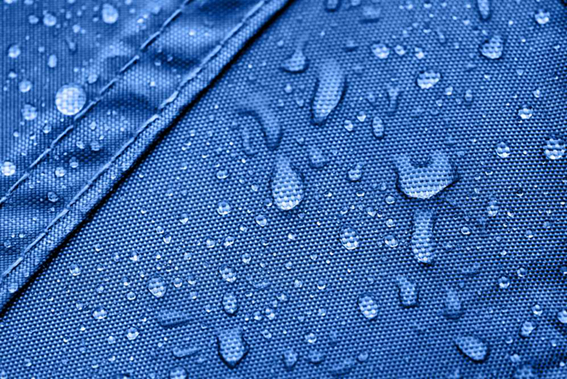 Dark blue rainproof tent sheet with morning rain drops